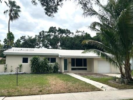 single story home featuring a front yard and a garage