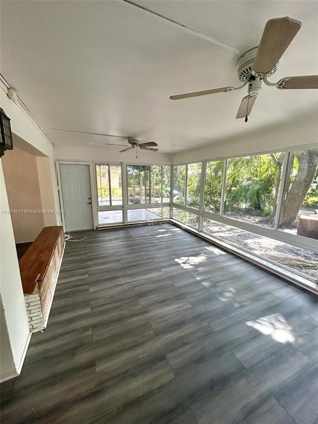 unfurnished sunroom featuring wood finished floors and ceiling fan