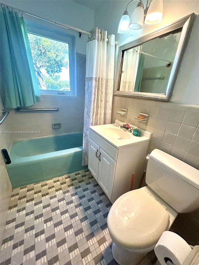 bathroom with toilet, vanity, shower / bathtub combination with curtain, tile patterned flooring, and tile walls