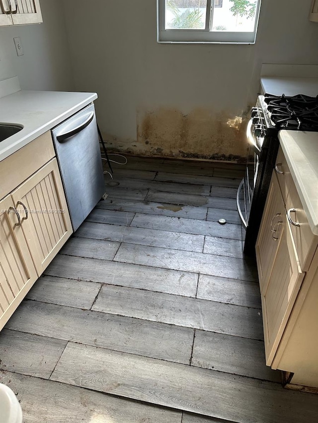 kitchen featuring light countertops, appliances with stainless steel finishes, and wood finished floors