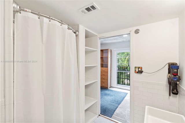 bathroom with tile walls