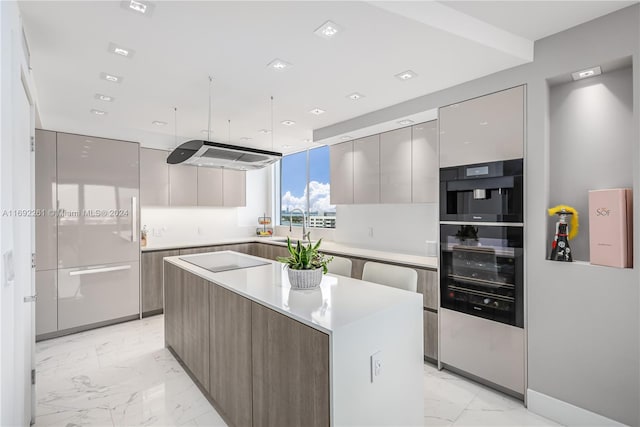 kitchen with black oven, sink, and a center island