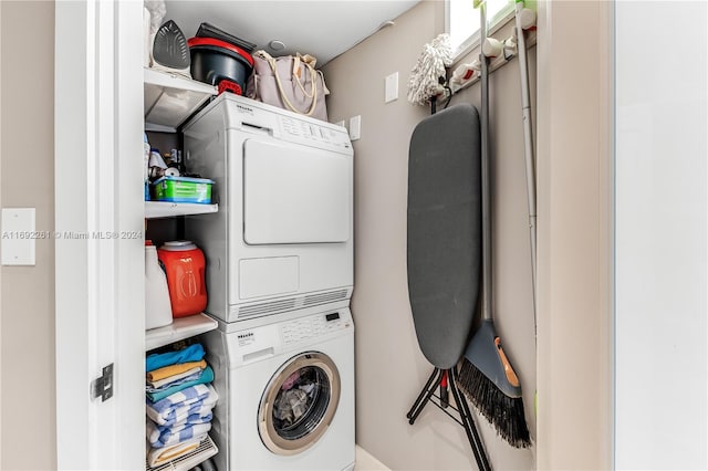 washroom featuring stacked washing maching and dryer