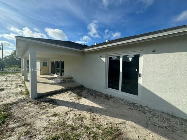 view of side of property with a patio