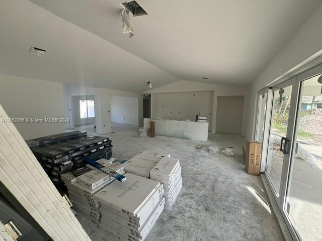 unfurnished living room with lofted ceiling