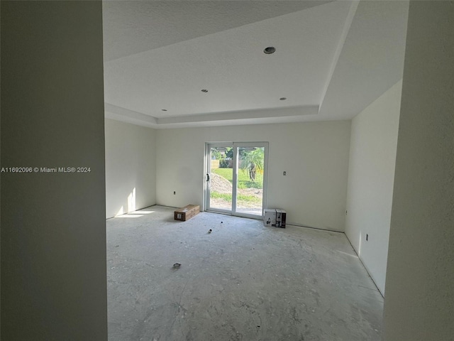 spare room featuring a raised ceiling