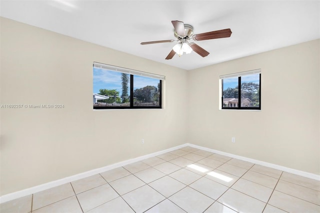 tiled empty room with ceiling fan