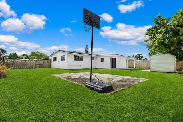 back of house featuring a storage unit, a lawn, and a patio