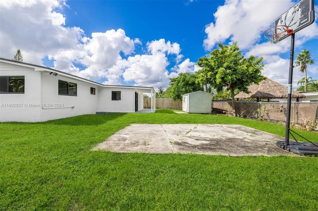 view of yard with a patio and a storage shed