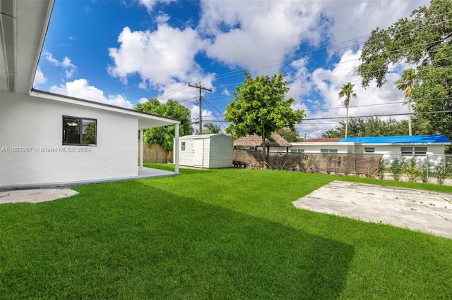 view of yard with a shed and a patio