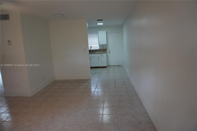 spare room featuring light tile patterned floors and sink