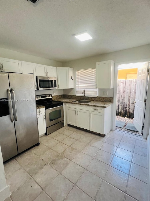 kitchen featuring white cabinets, sink, a healthy amount of sunlight, and stainless steel appliances