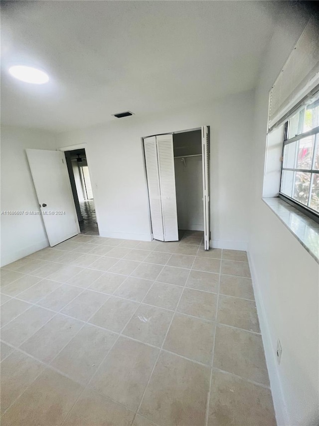 unfurnished bedroom with light tile patterned floors