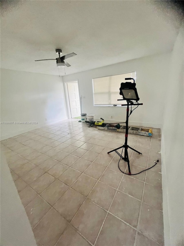 interior space featuring ceiling fan and light tile patterned floors