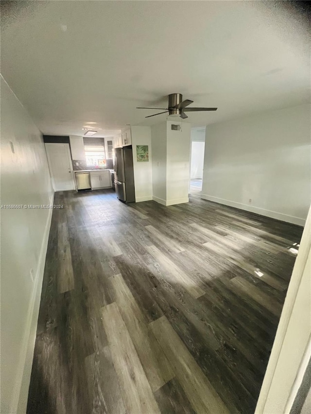 unfurnished living room with dark wood-type flooring and ceiling fan