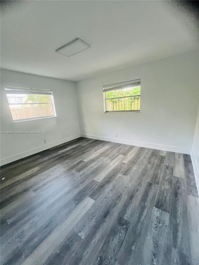 spare room with dark hardwood / wood-style flooring