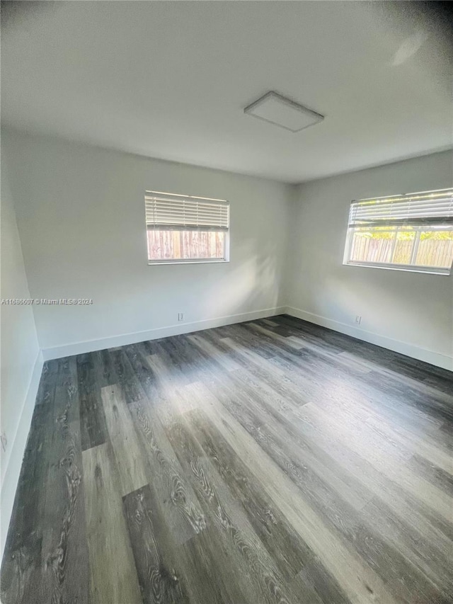 empty room featuring dark hardwood / wood-style floors and plenty of natural light