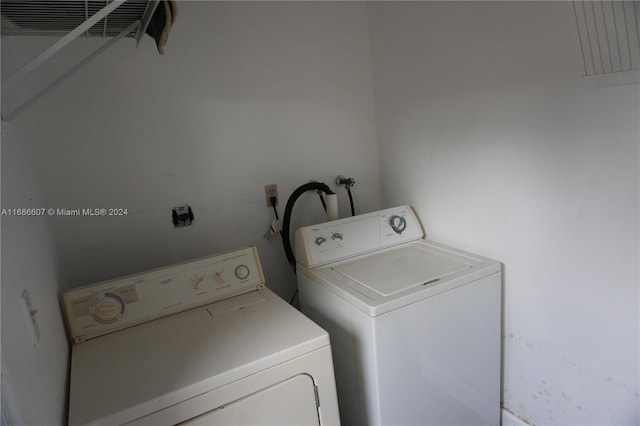 laundry area with independent washer and dryer