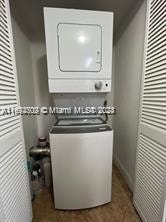 laundry area featuring stacked washer and clothes dryer