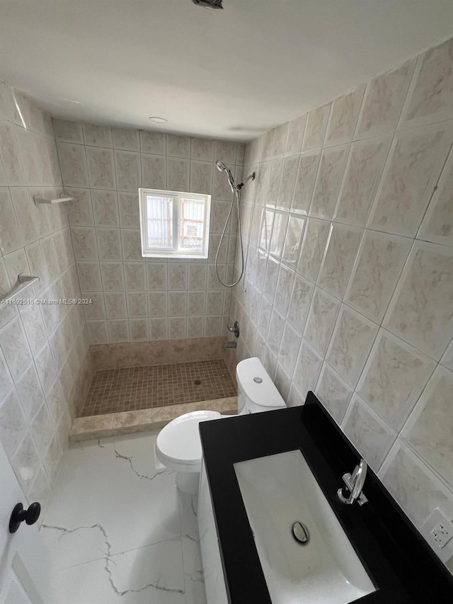 bathroom with toilet, tile walls, and tiled shower