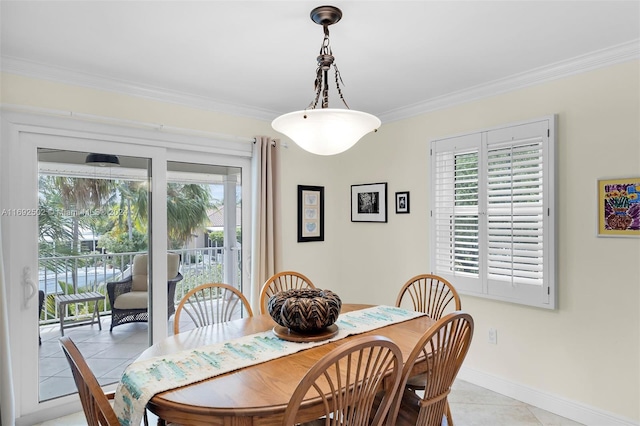 dining room with a wealth of natural light, light tile patterned floors, and crown molding