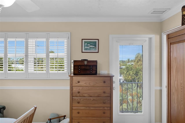 bedroom featuring a textured ceiling, ceiling fan, and crown molding