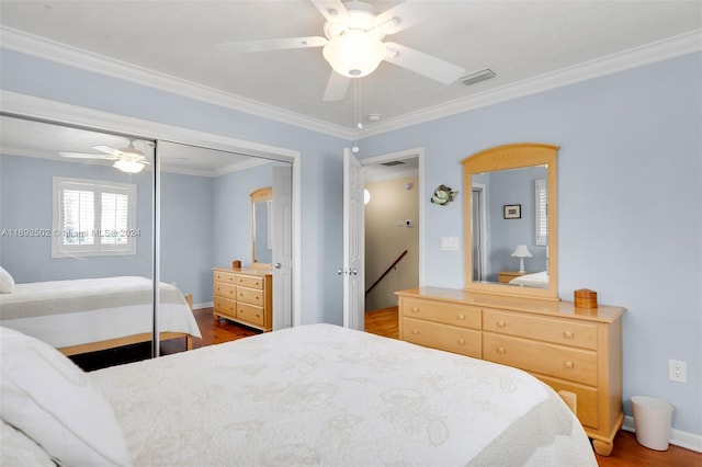 bedroom with wood-type flooring, ceiling fan, a closet, and ornamental molding