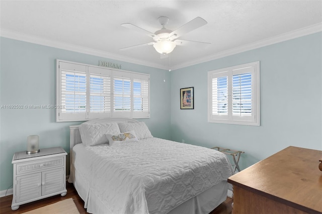 bedroom with hardwood / wood-style flooring, ceiling fan, multiple windows, and crown molding