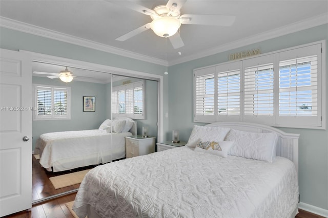 bedroom with dark hardwood / wood-style floors, ceiling fan, and multiple windows