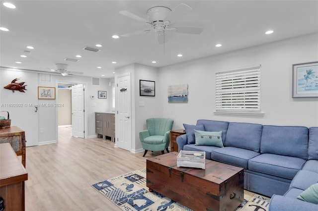 living room with light wood-type flooring and ceiling fan