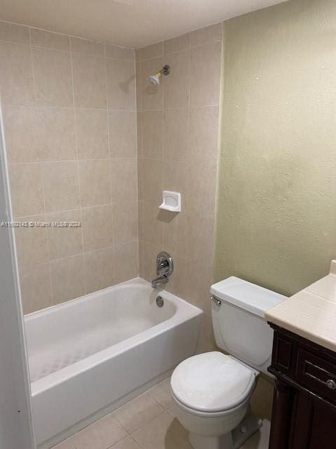 full bathroom with tile patterned floors, vanity, toilet, and tiled shower / bath combo