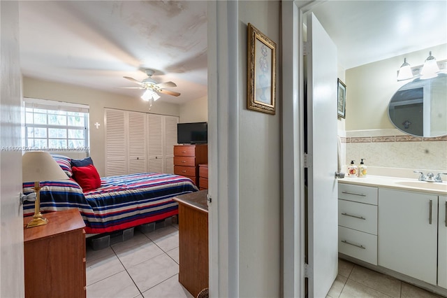 tiled bedroom featuring sink and ceiling fan