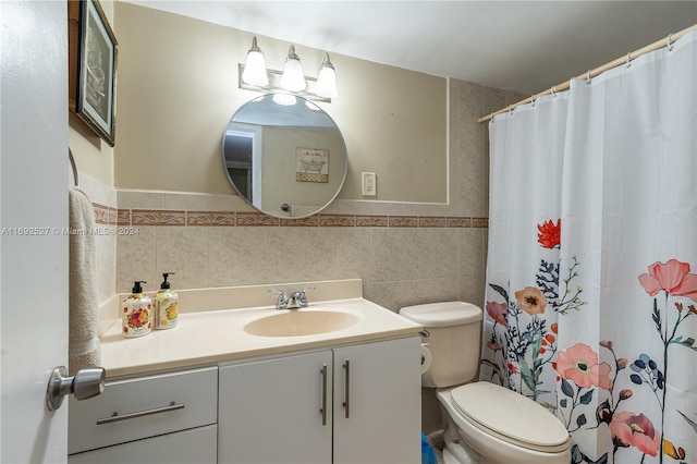 bathroom featuring a shower with curtain, vanity, toilet, and tile walls