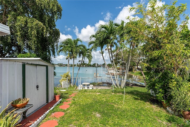 view of yard featuring a shed and a water view