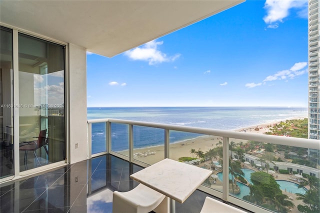 balcony with a beach view and a water view