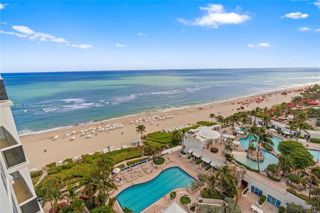 aerial view with a water view and a beach view