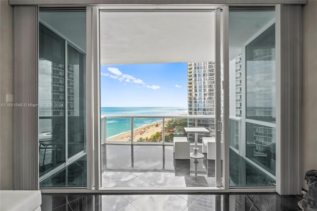 balcony featuring a water view and a beach view