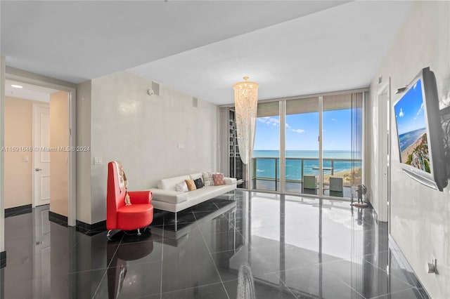 tiled living room with a chandelier and a wall of windows