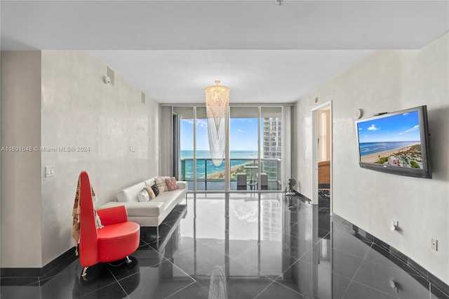 tiled living room with a chandelier and expansive windows