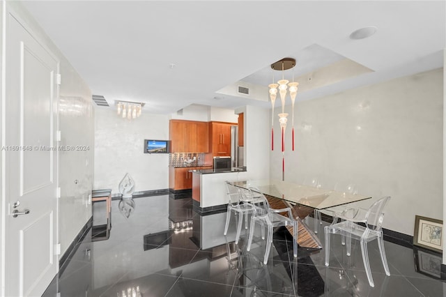 18101 Collins Ave Unit 1502, Sunny Isles Beach, FL 33160 - dining room featuring baseboards, granite floors, a tray ceiling, and a chandelier