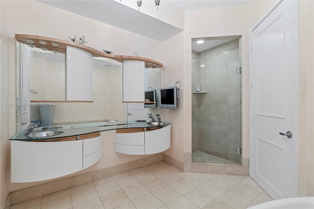 bathroom featuring tile patterned floors, vanity, and a shower with door