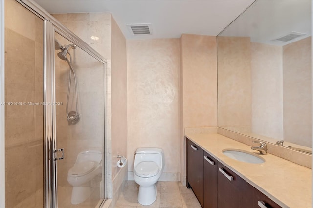 bathroom with tile patterned floors, vanity, toilet, and walk in shower