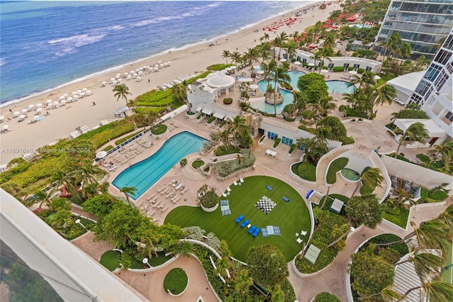 drone / aerial view featuring a water view and a beach view