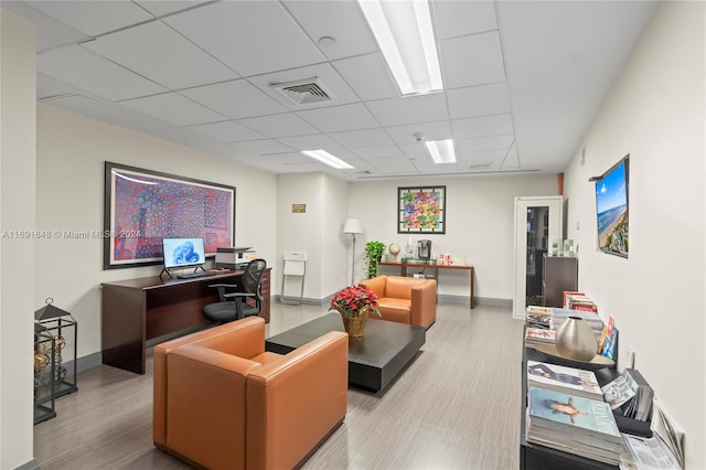 office space featuring a drop ceiling and wood-type flooring