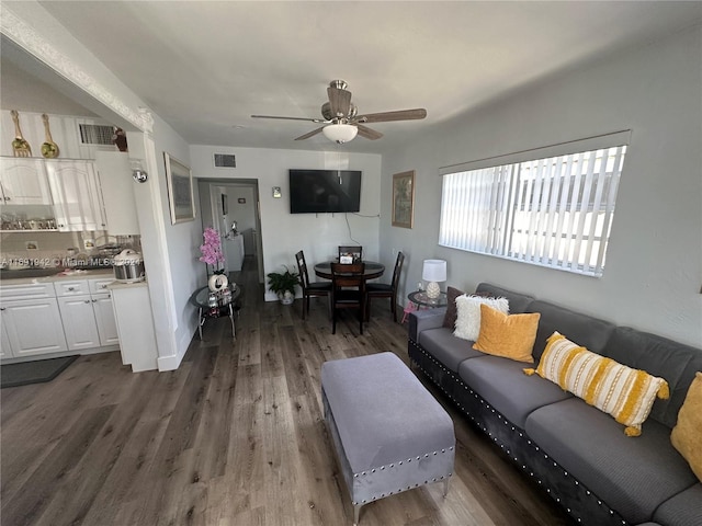 living room with ceiling fan and dark hardwood / wood-style floors