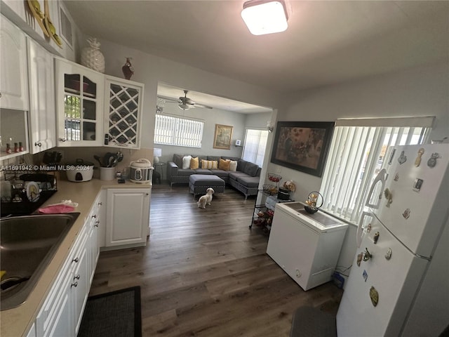 kitchen featuring sink, dark hardwood / wood-style floors, white refrigerator, fridge, and white cabinets