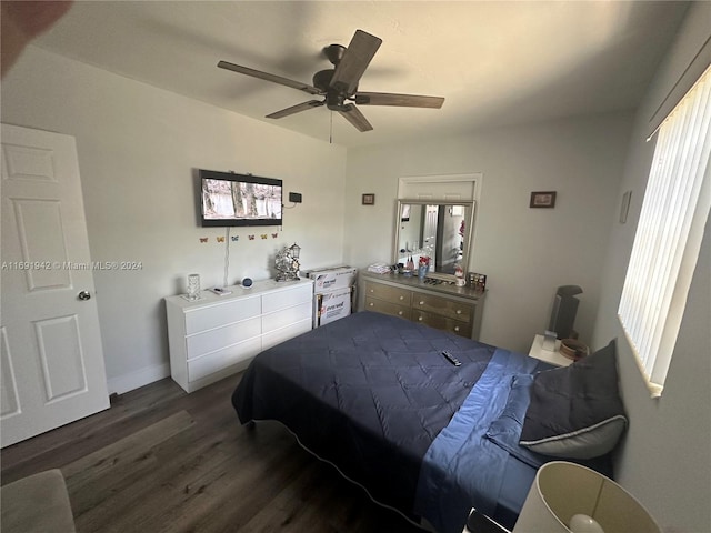 bedroom with ceiling fan and dark wood-type flooring