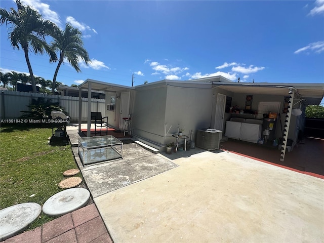 back of property featuring a patio and cooling unit