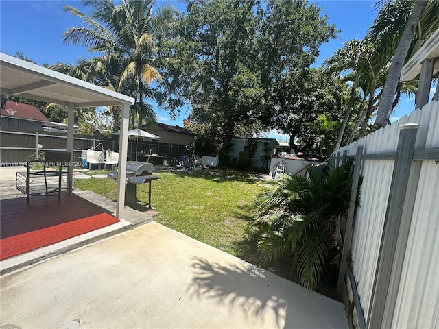 view of yard featuring a patio area and a wooden deck