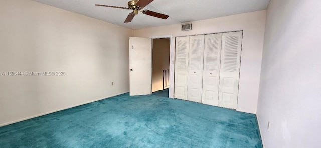 unfurnished bedroom with ceiling fan, dark carpet, and a closet